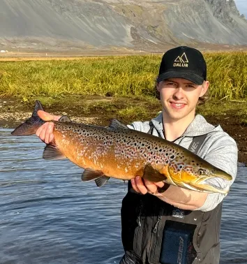 Happy traveler holding an Atlantic Salmon